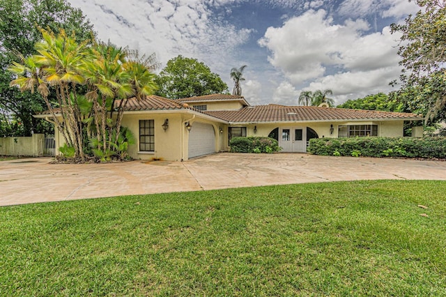 view of front of property with a garage and a front lawn