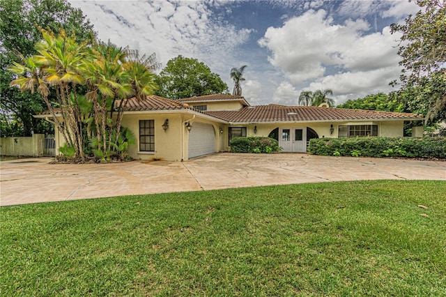 view of front of property featuring a garage and a front yard