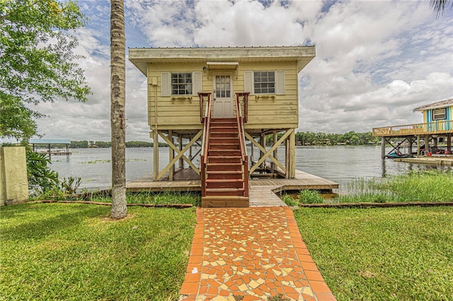 dock area with a water view and a yard