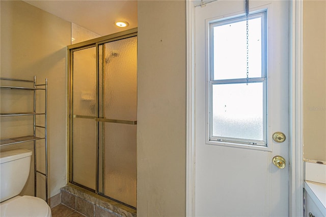 bathroom featuring an enclosed shower, vanity, and toilet