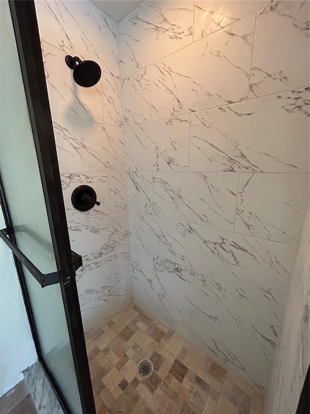 bathroom with tiled shower