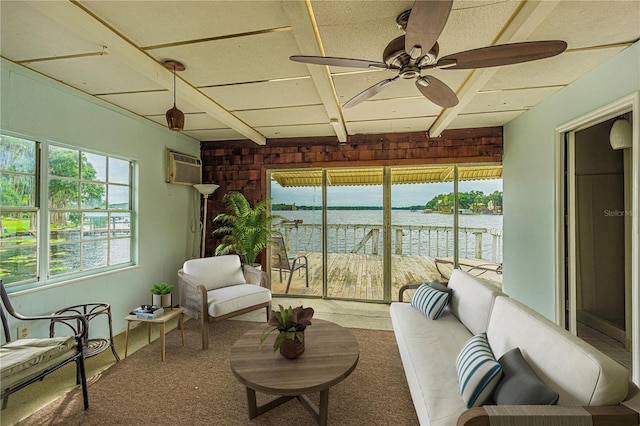 sunroom / solarium with beam ceiling, ceiling fan, a water view, and a wall unit AC