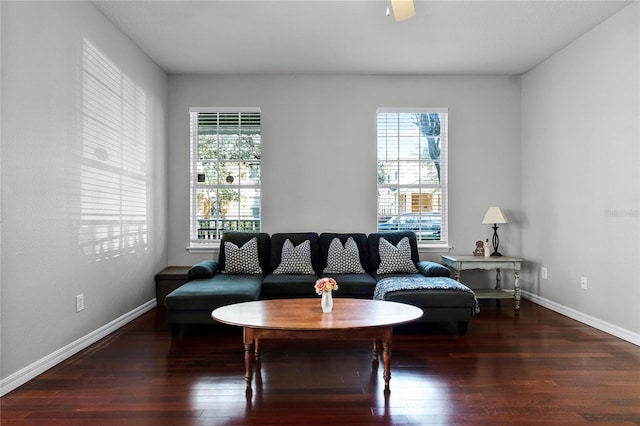 living room featuring ceiling fan, plenty of natural light, and dark hardwood / wood-style flooring