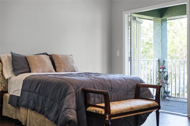 bedroom with hardwood / wood-style flooring and access to exterior