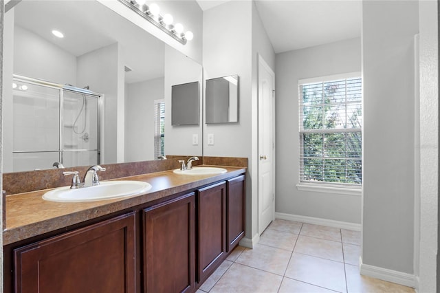 bathroom featuring vanity, a shower with shower door, and tile patterned flooring