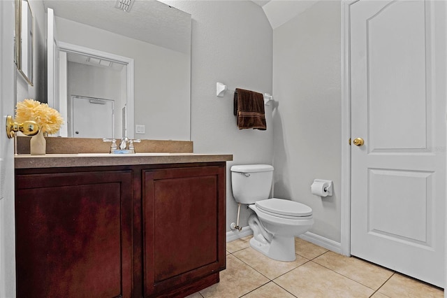 bathroom featuring toilet, tile patterned flooring, and vanity