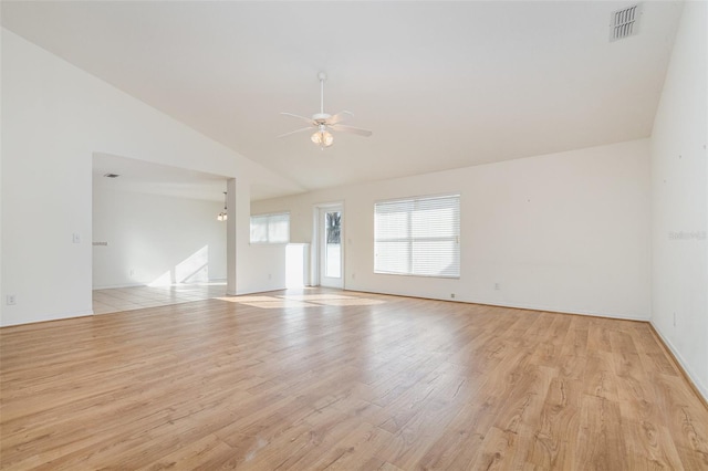 empty room with ceiling fan, high vaulted ceiling, and light wood-type flooring