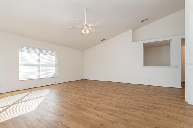 spare room with high vaulted ceiling, visible vents, light wood-style floors, and a ceiling fan