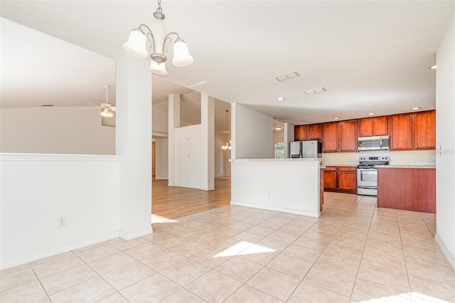 kitchen with light tile patterned flooring, open floor plan, and stainless steel appliances