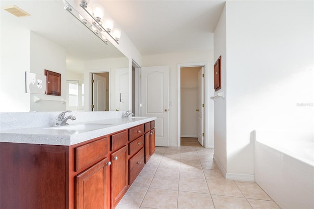 bathroom with visible vents, a closet, double vanity, tile patterned floors, and a sink