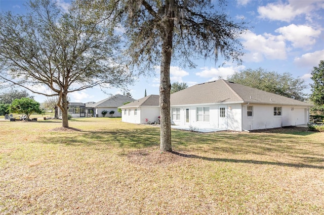 back of house with a lawn