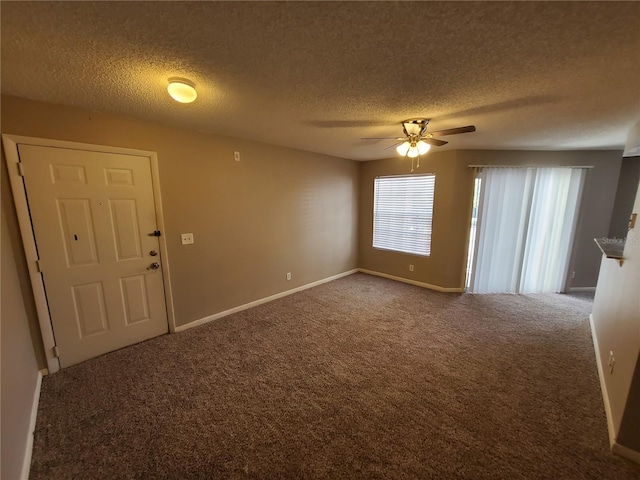 empty room with ceiling fan, a textured ceiling, and carpet flooring