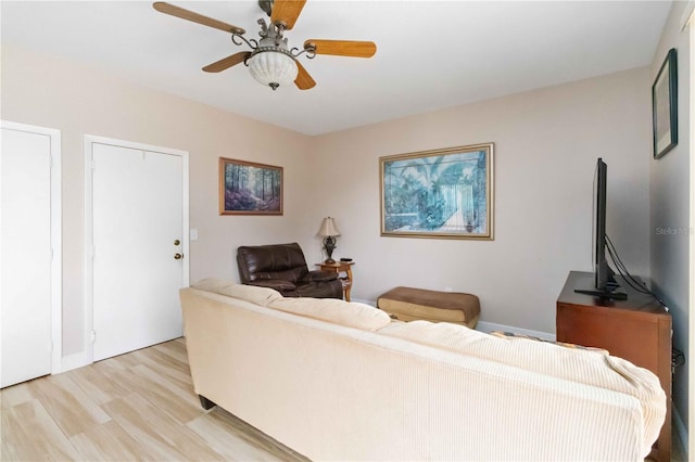 living room with ceiling fan and light wood-type flooring