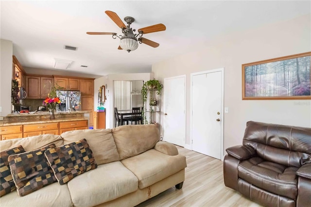 living room featuring light hardwood / wood-style floors and ceiling fan