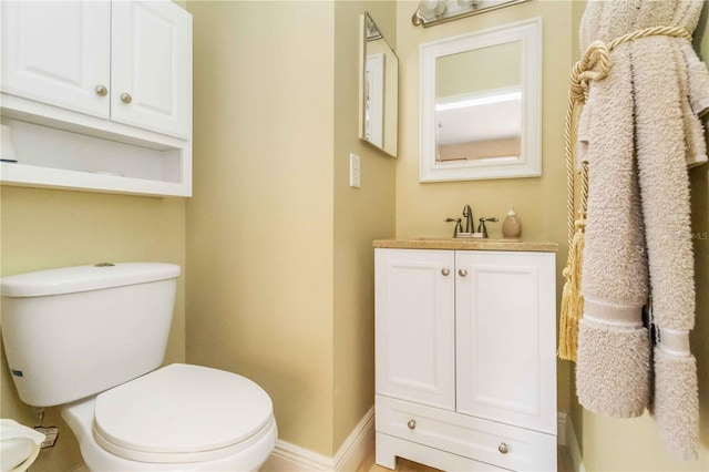 bathroom with toilet and vanity