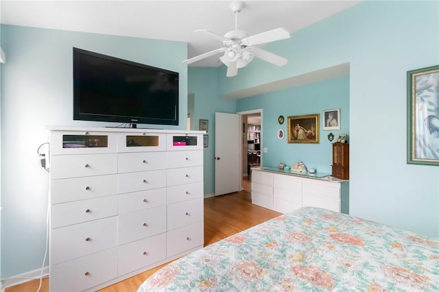 bedroom with light wood-type flooring, vaulted ceiling, and ceiling fan