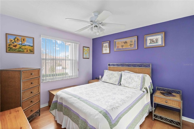 bedroom with ceiling fan and light hardwood / wood-style floors