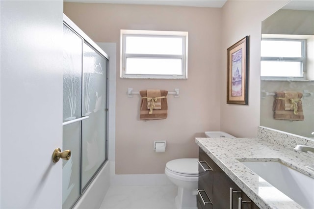 full bathroom featuring combined bath / shower with glass door, vanity, toilet, and tile patterned flooring