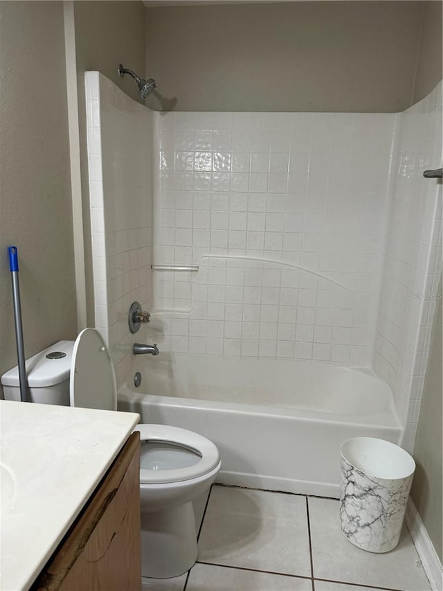 full bathroom with vanity, tile patterned floors, washtub / shower combination, and toilet