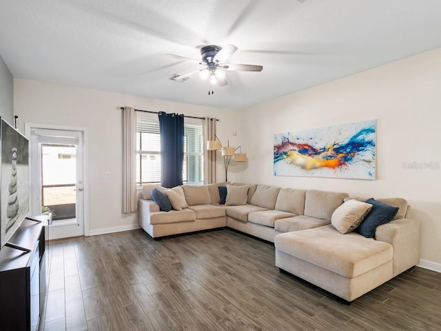 living room featuring ceiling fan and dark hardwood / wood-style floors