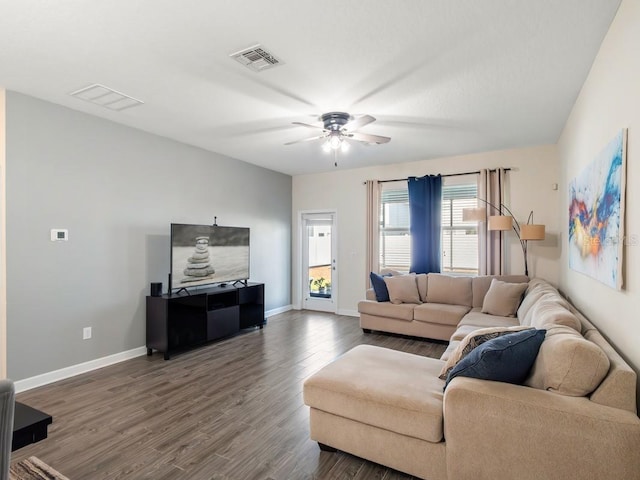 living room with dark wood-type flooring and ceiling fan