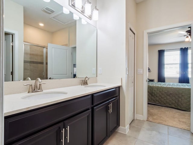 bathroom featuring ceiling fan, vanity, a shower with door, and tile patterned flooring