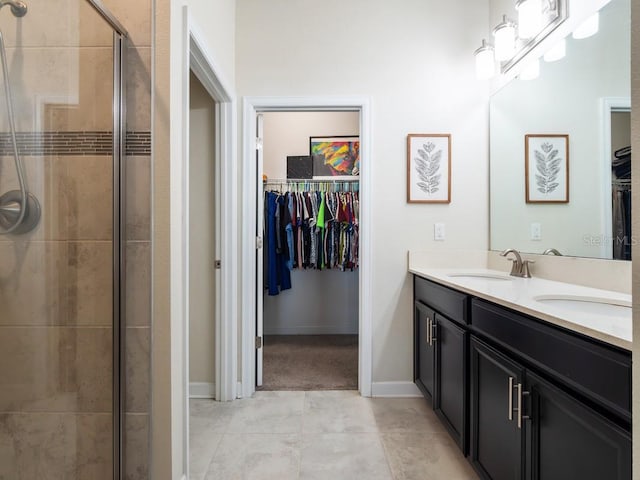 bathroom featuring a shower with door and vanity