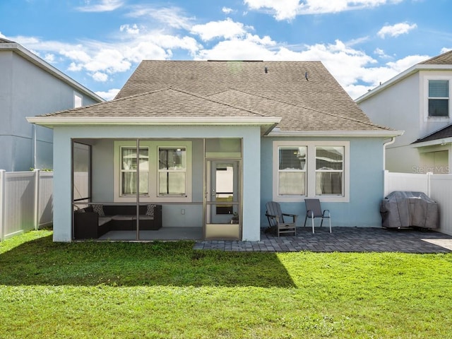 rear view of house with a yard and a patio area