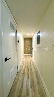 hall with wood finished floors and baseboards