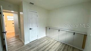 interior space featuring a closet, visible vents, and light wood-style flooring