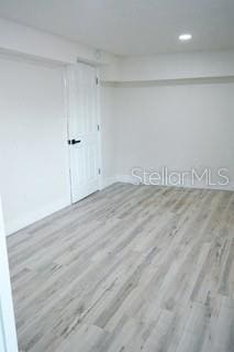 unfurnished room with light wood-style flooring