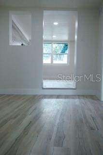 unfurnished room featuring wood finished floors and baseboards