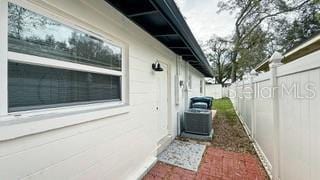 view of property exterior with a fenced backyard and central air condition unit