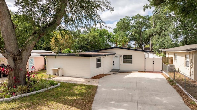 2002 Geigel Ave, Orlando, FL 32806 - view of front facade featuring central AC unit, concrete driveway, a gate, and fence