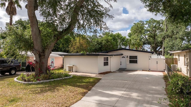 2002 Geigel Ave, Orlando, FL 32806 - single story home featuring a gate, central AC, fence, concrete driveway, and a front lawn