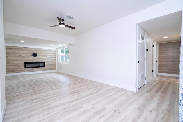 2002 Geigel Ave, Orlando, FL 32806 - unfurnished living room featuring wood finished floors, visible vents, a ceiling fan, baseboards, and a glass covered fireplace