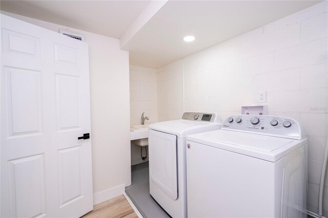 2002 Geigel Ave, Orlando, FL 32806 - laundry room with washer and clothes dryer, laundry area, visible vents, light wood finished floors, and baseboards