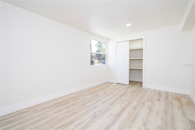 2002 Geigel Ave, Orlando, FL 32806 - unfurnished bedroom featuring baseboards, light wood-type flooring, a closet, and recessed lighting