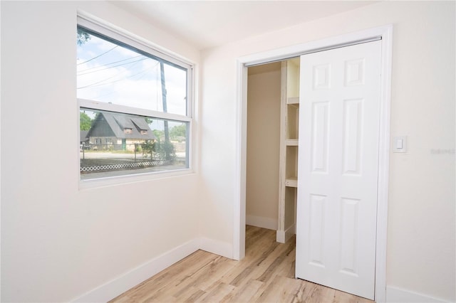 2002 Geigel Ave, Orlando, FL 32806 - unfurnished bedroom with baseboards and light wood-style floors