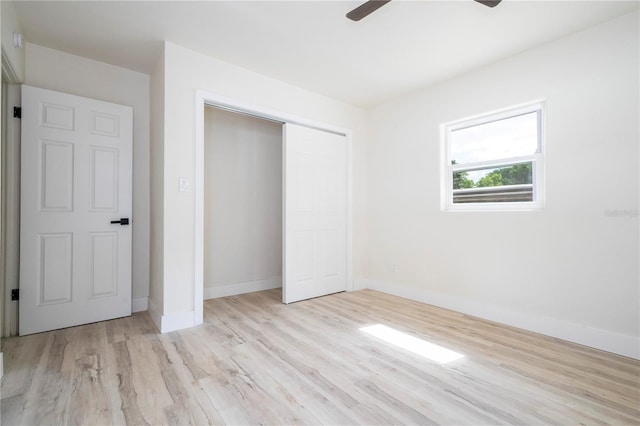 2002 Geigel Ave, Orlando, FL 32806 - unfurnished bedroom featuring a closet, a ceiling fan, wood finished floors, and baseboards