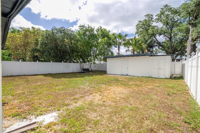2002 Geigel Ave, Orlando, FL 32806 - view of yard featuring an outbuilding, a fenced backyard, and a storage unit