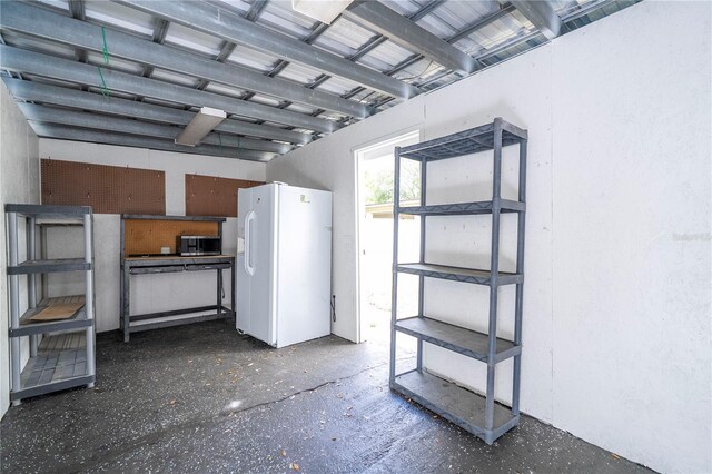 2002 Geigel Ave, Orlando, FL 32806 - garage featuring white refrigerator with ice dispenser