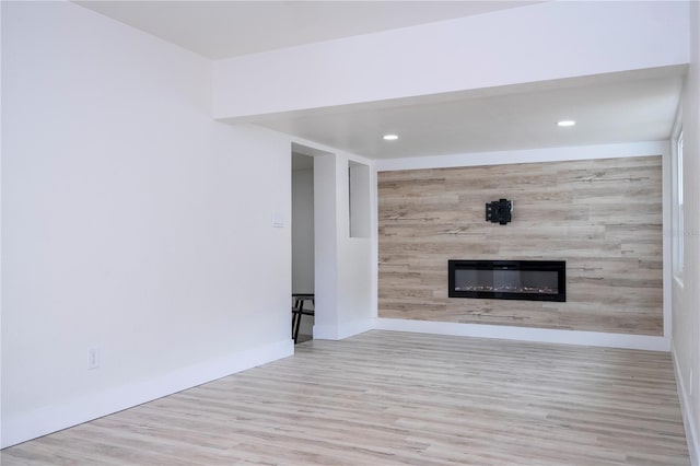 2002 Geigel Ave, Orlando, FL 32806 - unfurnished living room with a large fireplace, wood finished floors, baseboards, and recessed lighting