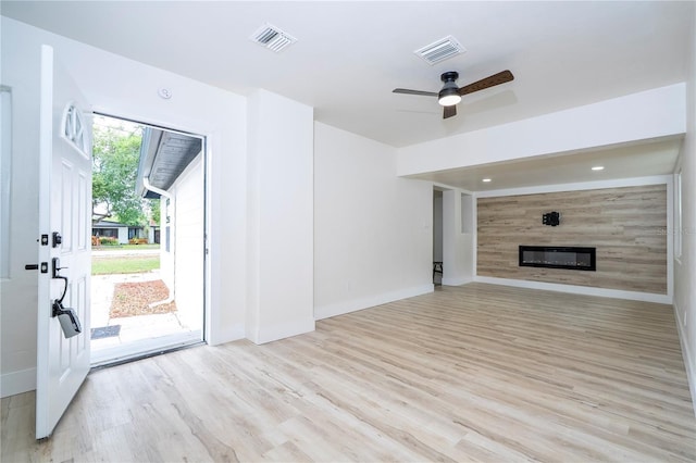 2002 Geigel Ave, Orlando, FL 32806 - unfurnished living room with visible vents, wood finished floors, and a glass covered fireplace