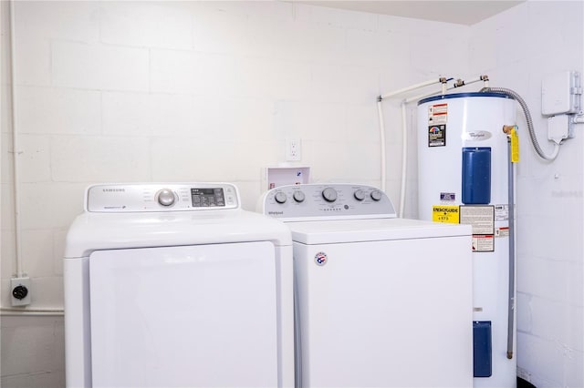 2002 Geigel Ave, Orlando, FL 32806 - laundry room featuring electric water heater, independent washer and dryer, and concrete block wall