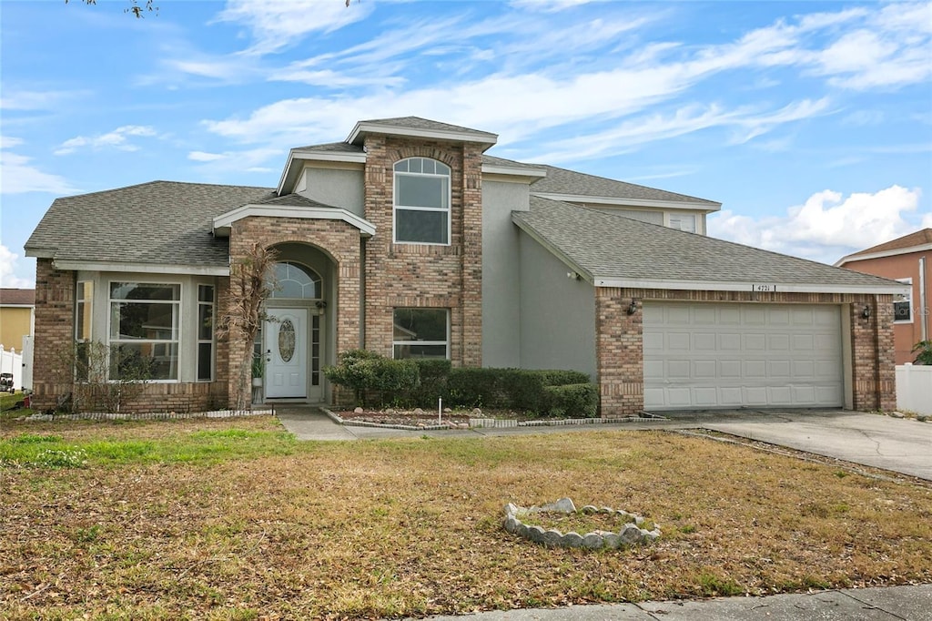 view of front of home with a garage and a front lawn