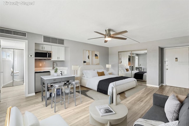 bedroom featuring sink and ceiling fan