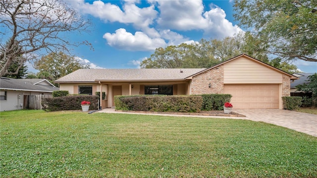 ranch-style home featuring a garage and a front lawn