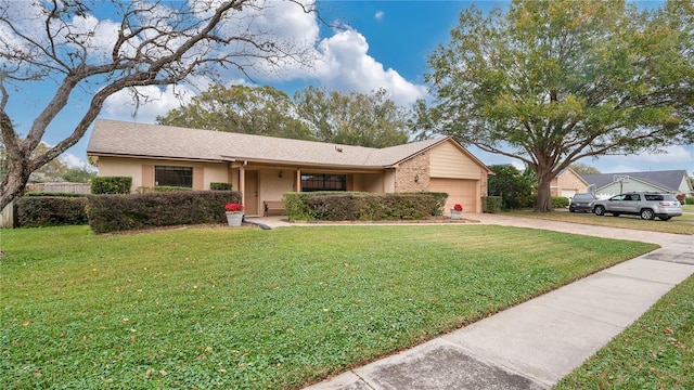 ranch-style house featuring a front yard and a garage