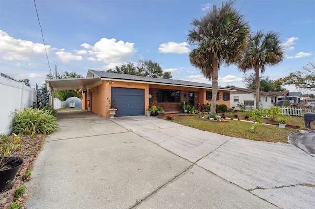 view of front of property with a carport, a garage, and a front lawn